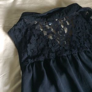 Sheer black sleeveless collared shirt with lace