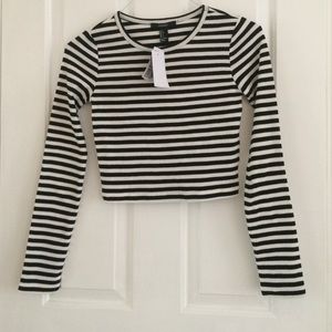 A black and white, stripped, crop top, long sleeve