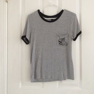 A black and grey t shirt with food on the pocket