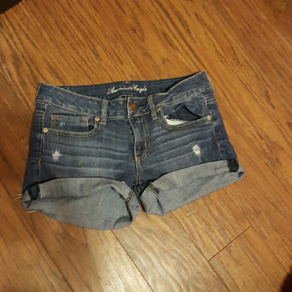medium wash lightly destroyed denim shorts