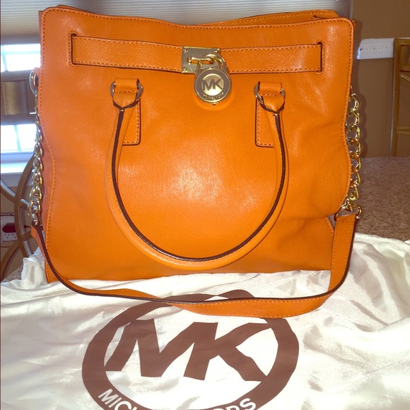 A  Michael Kors Orange purse.
