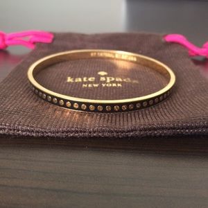 Black Kate Spade bangle with gold dots