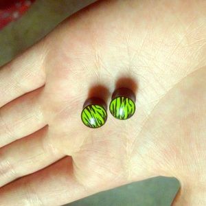 size 0 green and black zebra plugs gauges