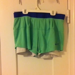 Blue and green nike running shorts