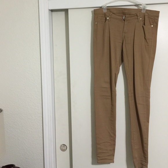 Khaki/ tan colored skinny, stretchy jeans.