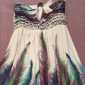 Strapless top by Skye. Falls past hips.