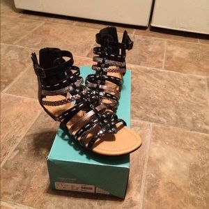 Cute gladiator shoes in black flats .