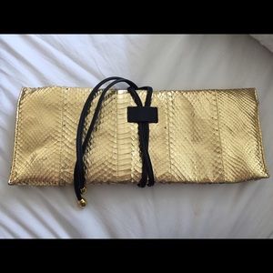 Franchi Gold leather Snake like clutch.