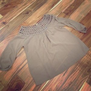 Sheer tan blouse with detailed neckline