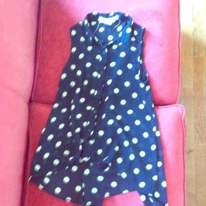 Sheer, black blouse with tan polka dots.