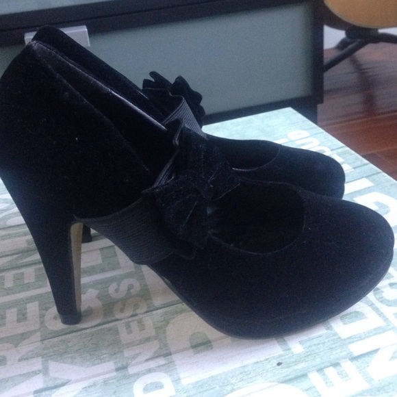 Black suede heels with bow straps