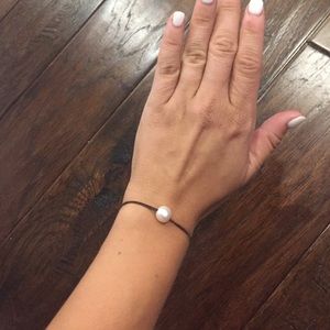 Pearl bead on brown leather