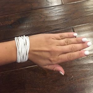 One bracelet with white strings
