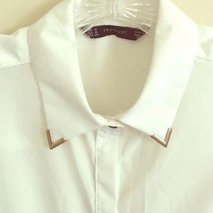 Sleeveless white top with gold tipped collar