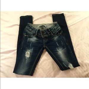 Dark washed destroyed denim jeans