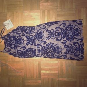 A blue laced mini halter neck dress.