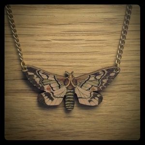 Elusive moth necklace. Laser cut wood collage
