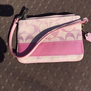 Light pink Coach wristlets