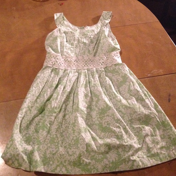 Green dress with a lace trim by waist.
