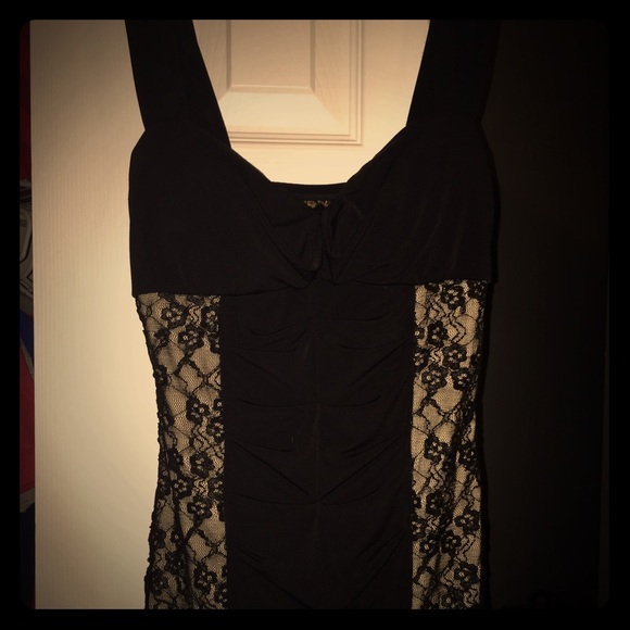 Short black dress with lace-style sides.