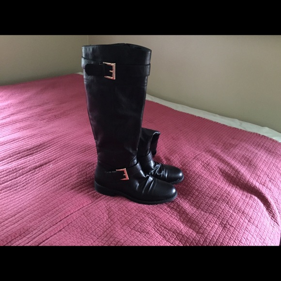 Black knee high boots with gold buckles