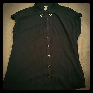 Black shirt with gold buttons and collar tips