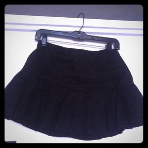 Black pleated mini skirt.