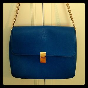 Cobalt blue bag with gold chain shoulder strap