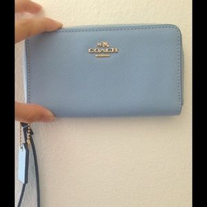 Light blue authentic Coach wristlet new (unused)