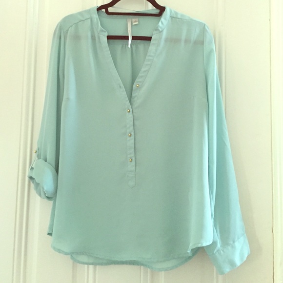Light blue blouse with gold buttons