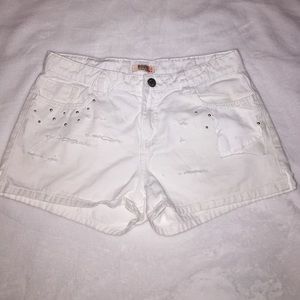 Torn up distressed white shorts