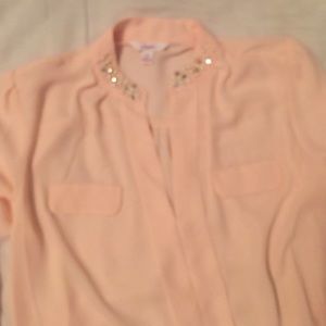 long sleeved pink blouse with a bejewled collar
