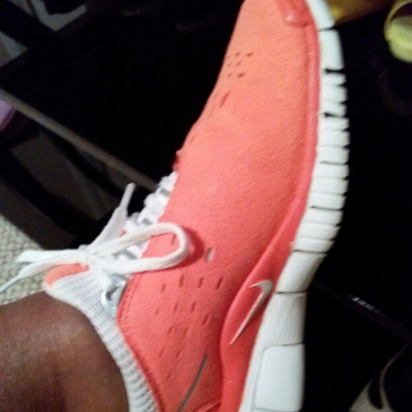 Nike sneakers tip of both shoes has wear on it.