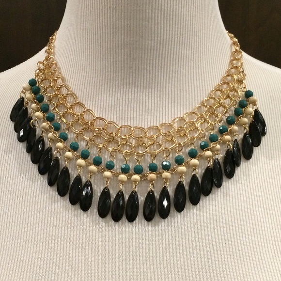 Green and beige beads with black water drops