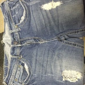 Boot cut denim jeans. Distressed.