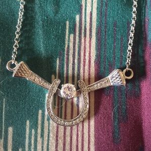 Horse shoe necklace with stone.