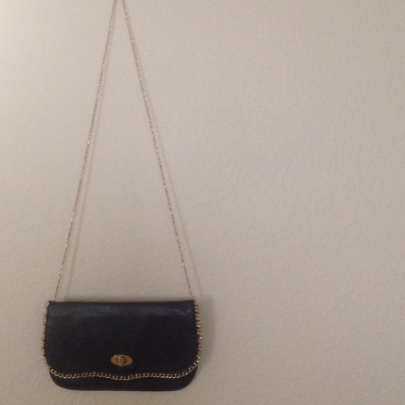 Black clutch with gold detail and chain