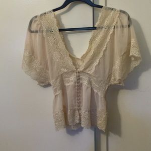 Nude sheer top with lace and buttons going down