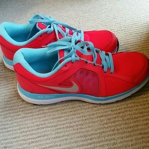 Neon pink/red and turquoise Nike running shoe