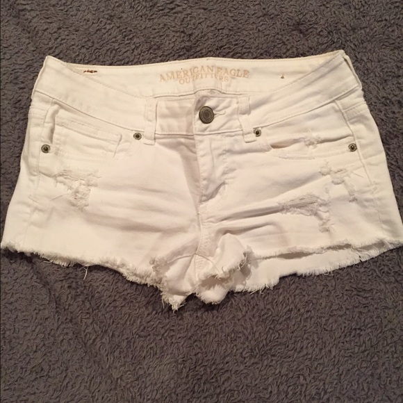 Distressed white denim shorts.
