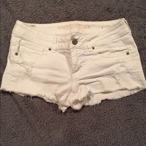 Distressed white denim shorts.