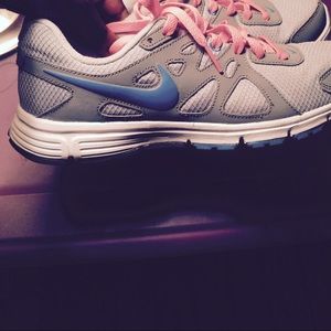 Grey Nike running shoes with pink laces