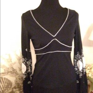 Free People embroidered long sleeve black top.