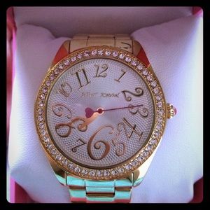 Gold betsey Johnson watch with diamonds.