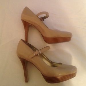 Nude and wood Mary Jane heels.