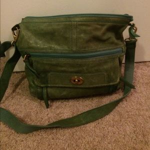 Green vintage fossil cross body purse.