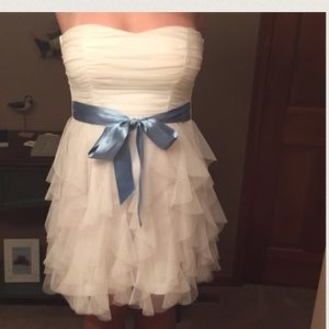 White cocktail dress with blue bow.
