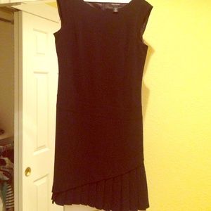 All black cocktail dress with pleaded skirt bottom