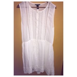 White dress with lace trims.