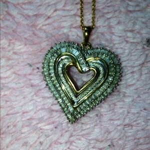 Sterling silver with gold overlay on CZ.